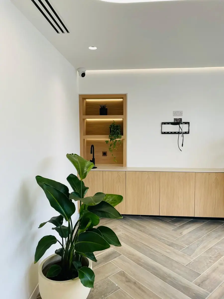 Built-in oak joinery with lit shelving