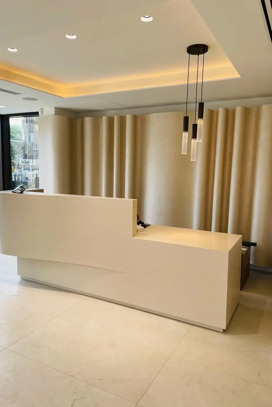 Curved, polished plaster wall behind a reception desk