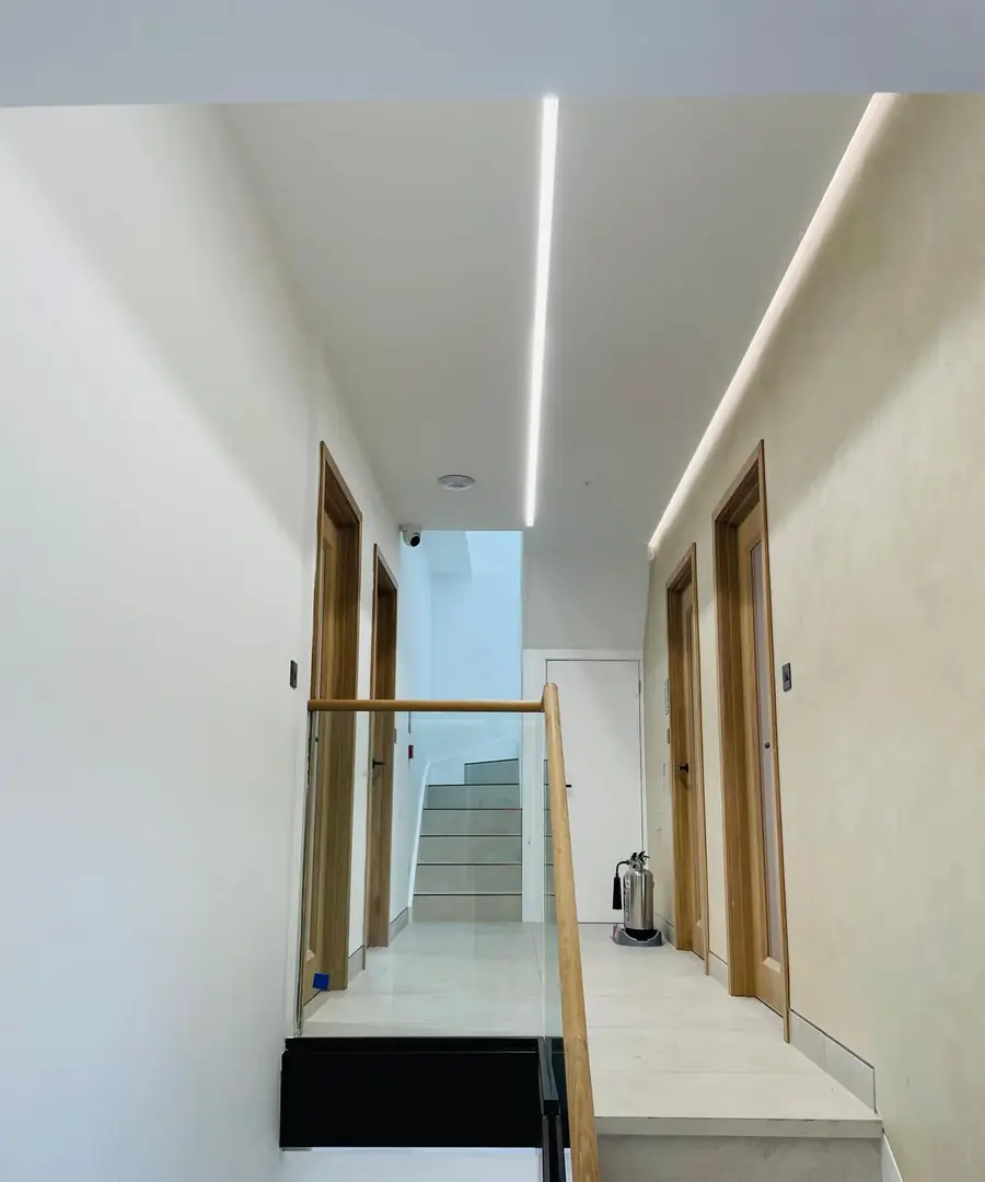 Stone staircase with an oak handrail and glass balustrade